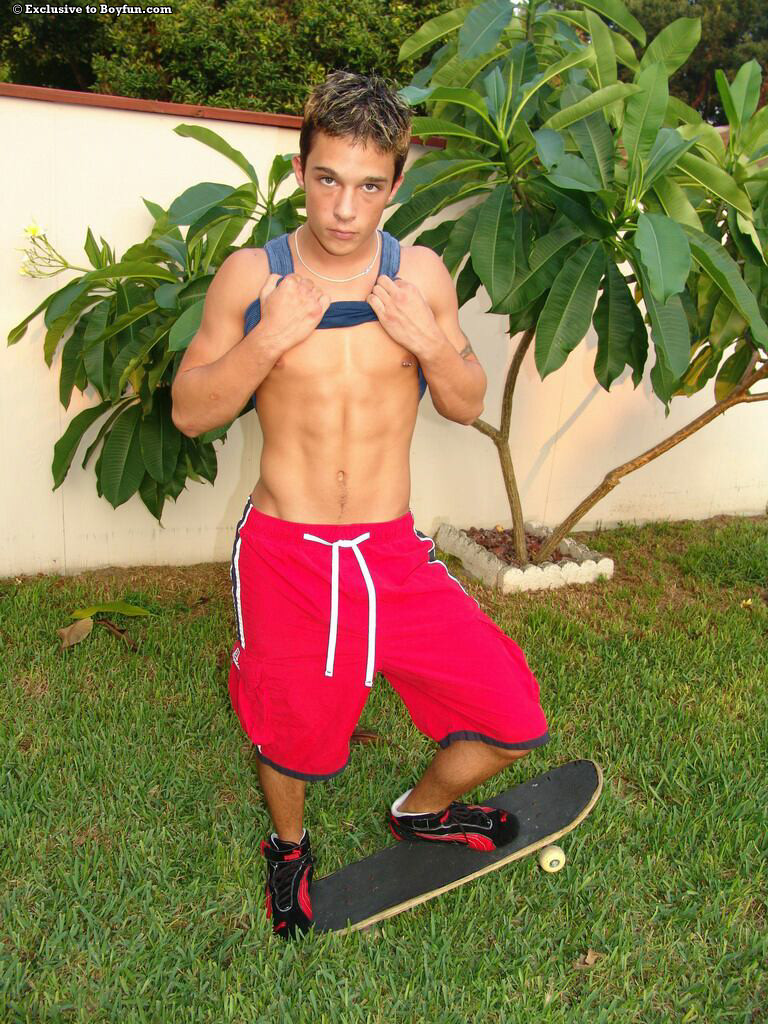 Kinky young gay skater Kyle shows his muscles and masturbates in the back yard  
