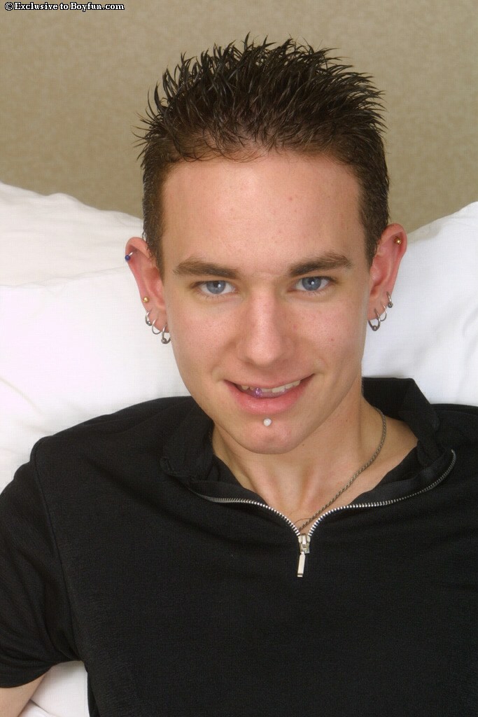 Cute pierced gay Leo doffs his clothes and jerks off his boner on a bed  